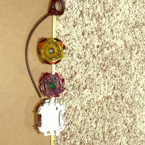 A yellow BEY BLADE with a purple